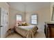 This bedroom features a comfy bed, a window, and a wooden dresser at 2123 Floral Ridge Dr, Dacula, GA 30019