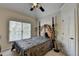 Comfortable bedroom featuring a plush bed, a ceiling fan and a window with blinds at 2123 Floral Ridge Dr, Dacula, GA 30019