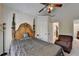 Cozy bedroom featuring a decorative four-poster bed and an adjacent private bathroom at 2123 Floral Ridge Dr, Dacula, GA 30019