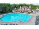Community clubhouse with a large pool, lounge chairs, and well-maintained grounds at 2123 Floral Ridge Dr, Dacula, GA 30019