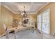 Formal dining room showcasing a large table, ornate decor, and coffered ceilings at 2123 Floral Ridge Dr, Dacula, GA 30019