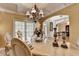 Elegant dining room featuring a coffered ceiling, chandelier, and decorative moldings at 2123 Floral Ridge Dr, Dacula, GA 30019