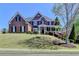 Beautiful two-story brick home with a well-manicured lawn and inviting front porch at 2123 Floral Ridge Dr, Dacula, GA 30019