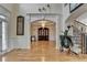 Stunning foyer with grand staircase, chandelier, and elegant architectural details at 2123 Floral Ridge Dr, Dacula, GA 30019