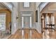 Spacious foyer with hardwood floors, decorative molding, and a view to formal areas at 2123 Floral Ridge Dr, Dacula, GA 30019