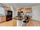 Well-lit kitchen boasts granite countertops, an island, and hardwood flooring at 2123 Floral Ridge Dr, Dacula, GA 30019