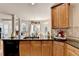 This lovely kitchen has a breakfast bar, granite countertops and wooden cabinets at 2123 Floral Ridge Dr, Dacula, GA 30019