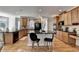 Modern kitchen featuring wooden cabinets, black appliances and kitchen island with seating at 2123 Floral Ridge Dr, Dacula, GA 30019