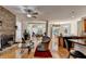 Open-concept living area with stone fireplace flowing to a dining area and kitchen at 2123 Floral Ridge Dr, Dacula, GA 30019