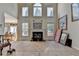 Bright living room featuring a fireplace, tall windows with natural light, and open floor plan at 2123 Floral Ridge Dr, Dacula, GA 30019