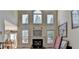 Bright living room boasts soaring ceilings, a fireplace, and large windows offering natural light at 2123 Floral Ridge Dr, Dacula, GA 30019