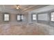 A spacious main bedroom that has tray ceilings and windows with trim at 2123 Floral Ridge Dr, Dacula, GA 30019