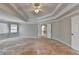 Large main bedroom showcasing tray ceilings, white trim, and large doorway at 2123 Floral Ridge Dr, Dacula, GA 30019