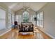 Bright sunroom with hardwood floors, large windows, and a vaulted ceiling with ceiling fan at 2123 Floral Ridge Dr, Dacula, GA 30019