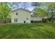 Spacious backyard with grass, white siding, and patio with stairs at 2202 Green Forrest Dr, Decatur, GA 30032