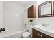 Cozy bathroom featuring tub shower, dark vanity, and decorative accents at 2202 Green Forrest Dr, Decatur, GA 30032