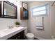 Bathroom featuring a shower, dark wood vanity, and a stylish mirror at 2202 Green Forrest Dr, Decatur, GA 30032