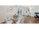 Bright dining room with hardwood floors, glass table, seating for four, and modern decor at 2202 Green Forrest Dr, Decatur, GA 30032