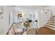 Open-concept dining room with glass table, hardwood floors, and natural light at 2202 Green Forrest Dr, Decatur, GA 30032