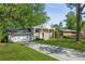 Traditional home with an attached garage, brick facade, and a well-manicured front lawn at 2202 Green Forrest Dr, Decatur, GA 30032