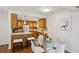 A functional kitchen and dining area featuring wood cabinets, a glass table and stainless steel appliances at 2202 Green Forrest Dr, Decatur, GA 30032