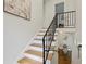 A bright staircase with wooden steps and an ornate wrought iron railing leads to the upper level at 2202 Green Forrest Dr, Decatur, GA 30032