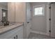 Bathroom with granite countertops, modern finishes, and tile floor at 7751 Capps Ridge Ln, Douglasville, GA 30135