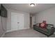 Cozy bedroom with a comfortable green couch and unique accent pillows at 7751 Capps Ridge Ln, Douglasville, GA 30135