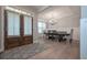 Hardwood floors lead to a dining area with elegant lighting and windows for natural light at 7751 Capps Ridge Ln, Douglasville, GA 30135