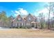 Charming two-story brick home with a welcoming front porch and well-maintained landscaping at 7751 Capps Ridge Ln, Douglasville, GA 30135