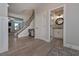 Welcoming foyer with hardwood floors, staircase, and a view of a powder room at 7751 Capps Ridge Ln, Douglasville, GA 30135