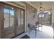 Covered front porch featuring double doors, brick walls, and seating for relaxing outdoors at 7751 Capps Ridge Ln, Douglasville, GA 30135