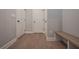 Hallway with bench seating, white trim, and attractive hardwood flooring at 7751 Capps Ridge Ln, Douglasville, GA 30135