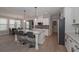 Modern kitchen features an island with bar seating, stainless steel appliances, and access to the dining room at 7751 Capps Ridge Ln, Douglasville, GA 30135