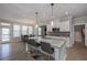 Spacious kitchen showcases an island with bar seating, stainless steel appliances, and access to the backyard at 7751 Capps Ridge Ln, Douglasville, GA 30135