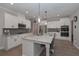 Bright kitchen showcases white cabinets, stainless steel appliances, a large island, and granite countertops at 7751 Capps Ridge Ln, Douglasville, GA 30135