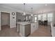 Modern kitchen features an island with bar seating, stainless steel appliances, and open access to other living areas at 7751 Capps Ridge Ln, Douglasville, GA 30135