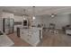 Modern white kitchen features stainless steel appliances and granite countertops at 7751 Capps Ridge Ln, Douglasville, GA 30135