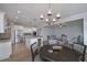 Open-concept kitchen and dining area features an island, stainless appliances, and modern lighting fixtures at 7751 Capps Ridge Ln, Douglasville, GA 30135