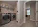Laundry room featuring side-by-side washer and dryer with tile floor at 7751 Capps Ridge Ln, Douglasville, GA 30135