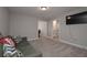 Comfortable living room with gray sofa and accent pillows and TV mounted on the wall at 7751 Capps Ridge Ln, Douglasville, GA 30135