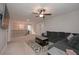 Open living room area with dark sofa, patterned rug, and ceiling fan at 7751 Capps Ridge Ln, Douglasville, GA 30135