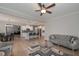Open-concept living room boasts hardwood floors and a gray tufted sofa at 7751 Capps Ridge Ln, Douglasville, GA 30135