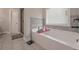 Relaxing main bathroom with soaking tub and stylish tile accents at 7751 Capps Ridge Ln, Douglasville, GA 30135