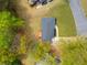 Aerial view of the home highlighting the roof, driveway, lawn, and the backyard's wooden deck at 974 Shirley Se St, Smyrna, GA 30082