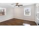 Bright bedroom with hardwood floors, ceiling fan, and closet with sliding doors at 974 Shirley Se St, Smyrna, GA 30082