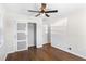 Bedroom features hardwood floors, a ceiling fan, and a closet with sliding doors at 974 Shirley Se St, Smyrna, GA 30082