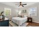 Bright bedroom with a cozy bed, ceiling fan, and dual windows offering natural light at 974 Shirley Se St, Smyrna, GA 30082