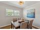 Cozy dining room featuring a dark wood table set, modern lighting, and a bright window view at 974 Shirley Se St, Smyrna, GA 30082