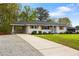 Exterior view of a one-story home with a carport, wood shutters, and a concrete driveway at 974 Shirley Se St, Smyrna, GA 30082